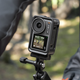 A DJI Osmo Action 3 action camera mounted to the handlebars of a bicycle.